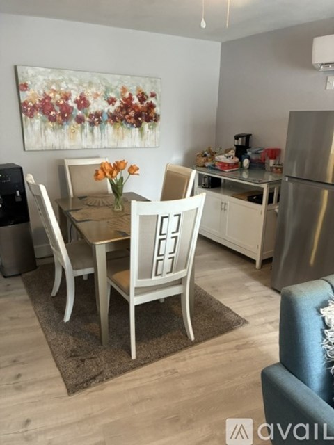 A dining room with a table set for four.