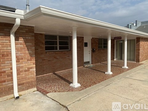 A building with a white roof and pillars with a sign that says "2051" on it.