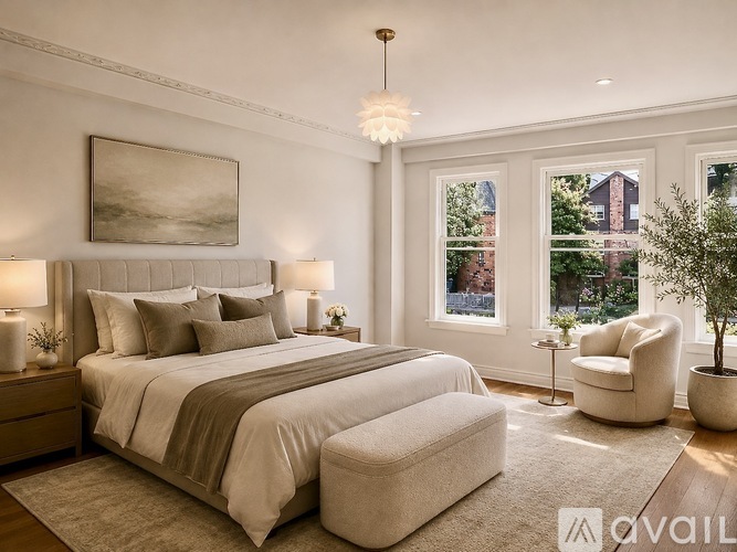 A bedroom with a large bed and a painting on the wall.