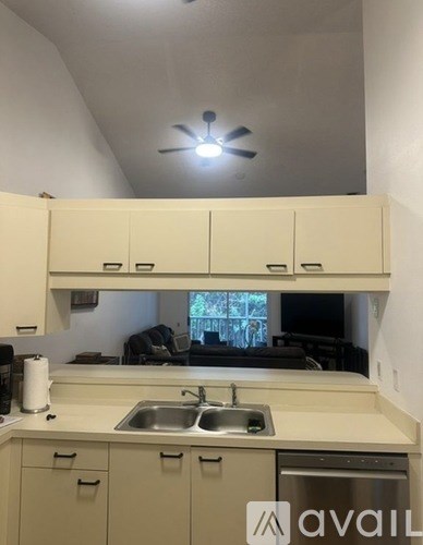 A kitchen with a sink and cabinets.