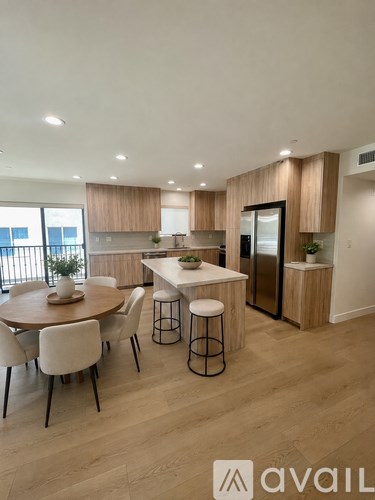 A modern kitchen with a dining table and chairs.