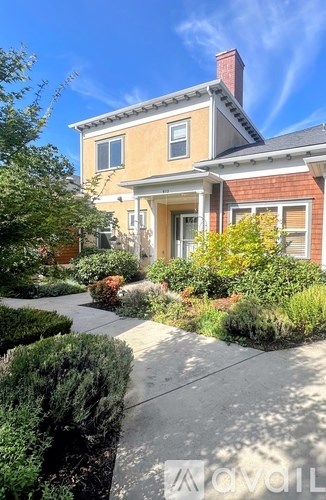 A house with a red brick exterior and a white trim is for sale.
