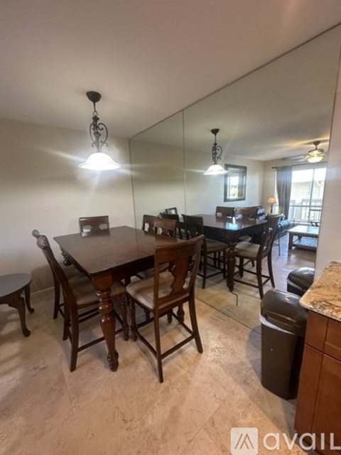 A dining room with a wooden table and chairs.