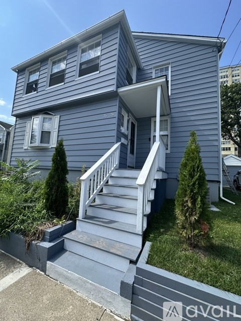 A house with a grey exterior and a white front door.