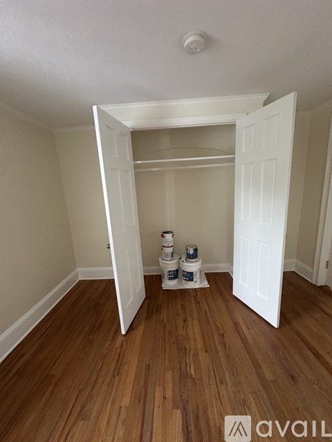 A room with wooden floors and a white door.