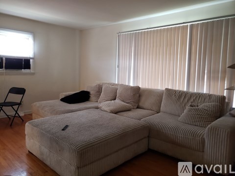 A living room with a striped couch and a chair.