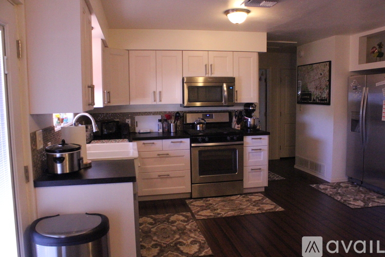 A kitchen with white cabinets and a black stove top.