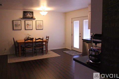 A dining room with a table and chairs.