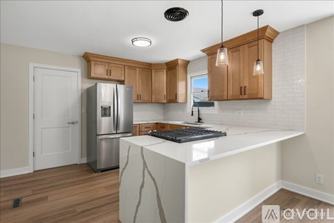 A kitchen with wooden cabinets and a white countertop.