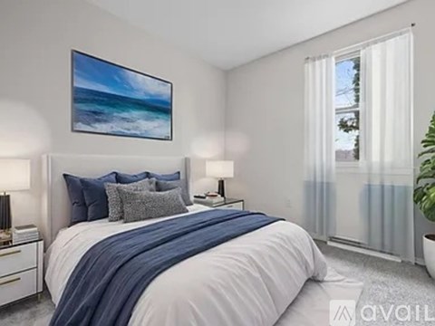 A bedroom with a large bed and a painting on the wall.