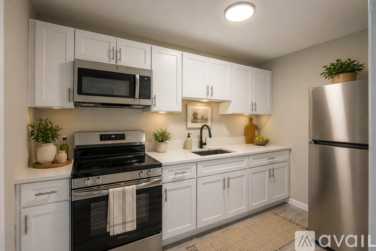 A kitchen with white cabinets and a black stove top oven.