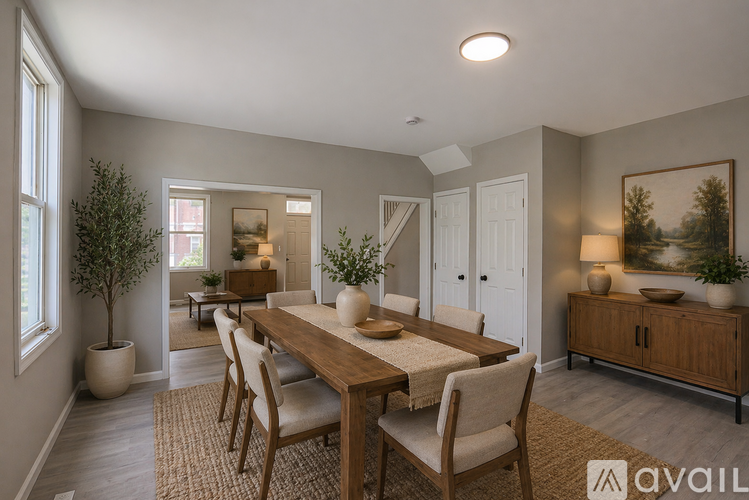 A dining room with a wooden table and chairs.