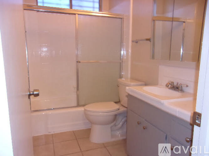 A bathroom with a toilet, sink, and shower.