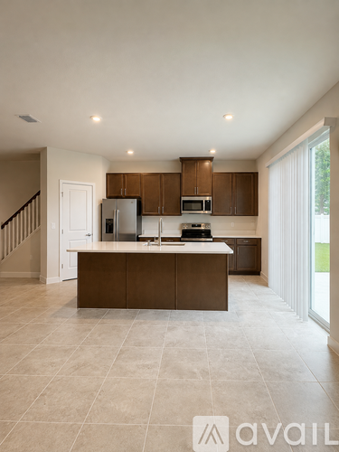 A kitchen with brown cabinets and a white refrigerator.