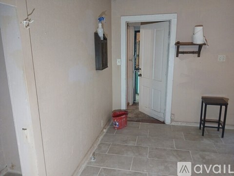 A room with a door, a table, and a window.
