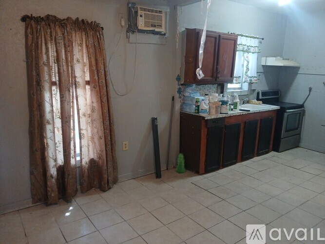A kitchen area with a counter and a microwave.