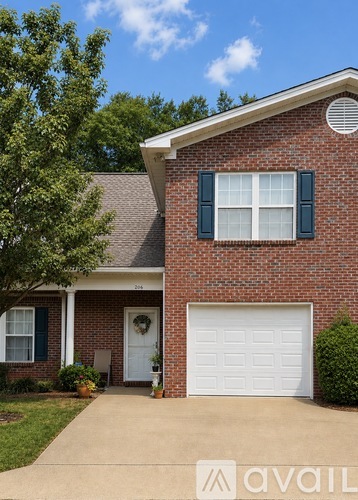 A red brick house with a white garage door.