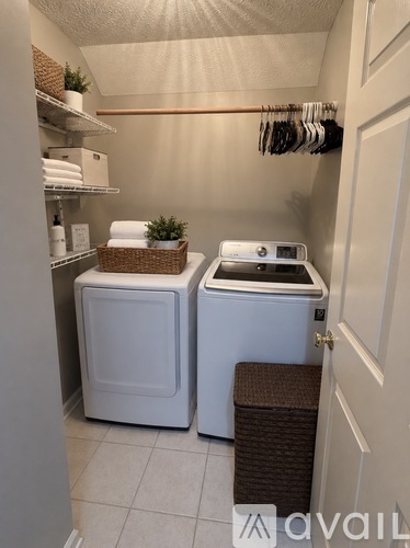 A small laundry room with a washer and dryer.
