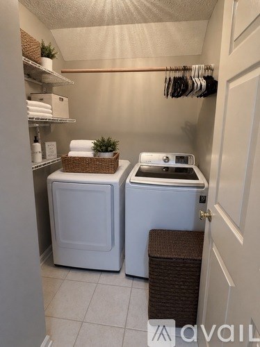 A small laundry room with a washer and dryer.
