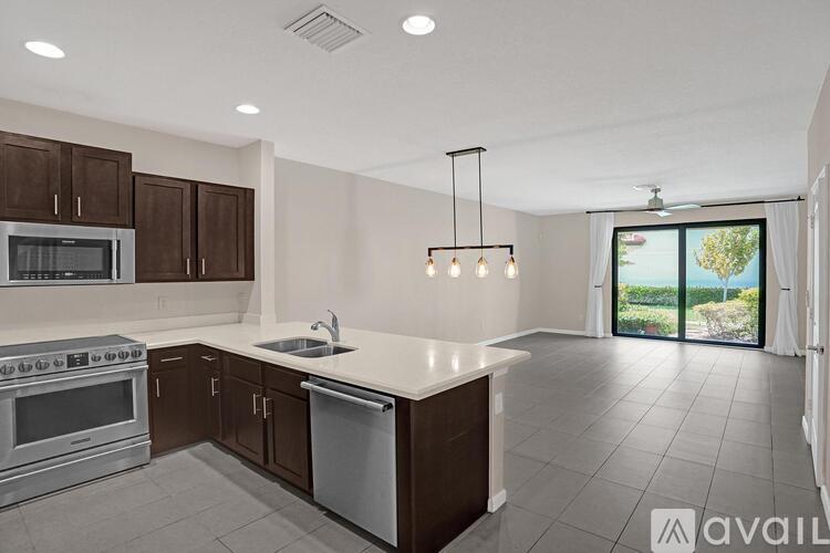 A kitchen with brown cabinets and a white countertop.