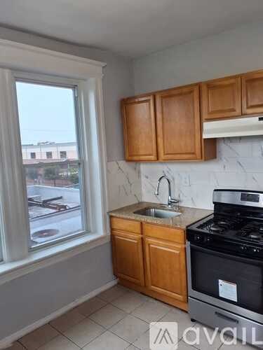 A kitchen with wooden cabinets and a black stove.