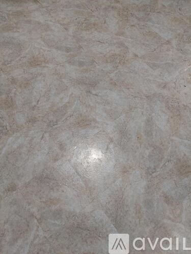 A close up of a marble-like surface with a logo in the bottom right corner.