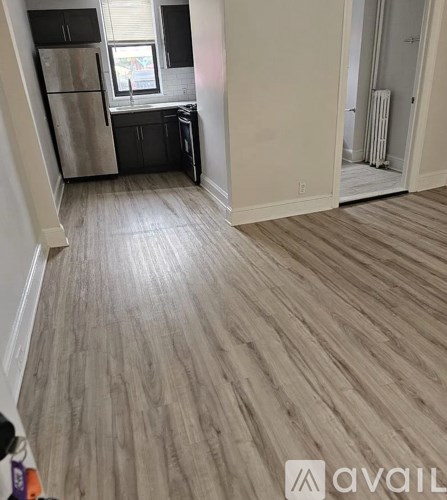 A room with wooden flooring and a window.