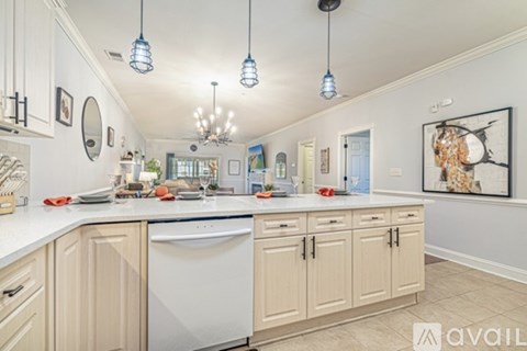 A kitchen with white cabinets and a white countertop.
