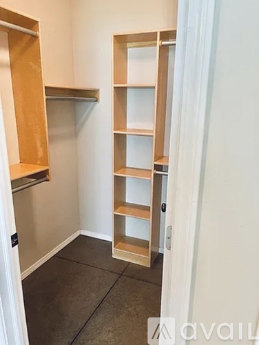 A room with a shelving unit and a door.