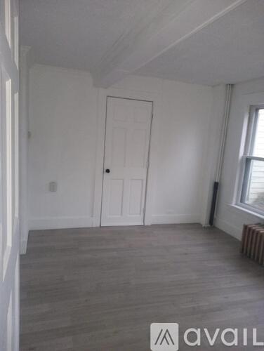 A room with a door and a window.