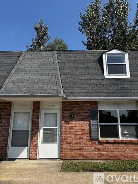 A house with a white door and a window with a black frame.