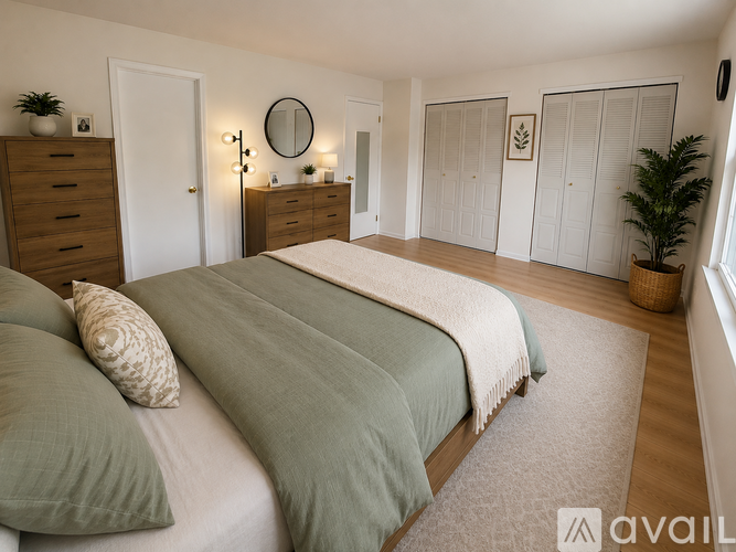 A bedroom with two beds and a dresser.