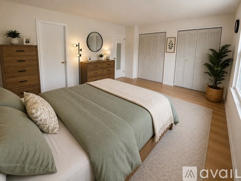 A bedroom with two beds and a dresser.