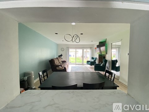 A dining room with a table and chairs.