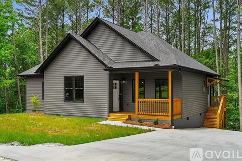 A house with a grey exterior and a wooden porch.