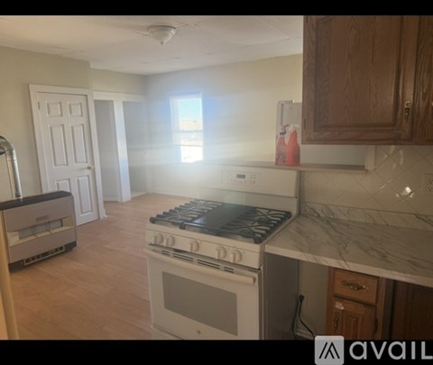 A kitchen with a stove, oven, and cabinets.