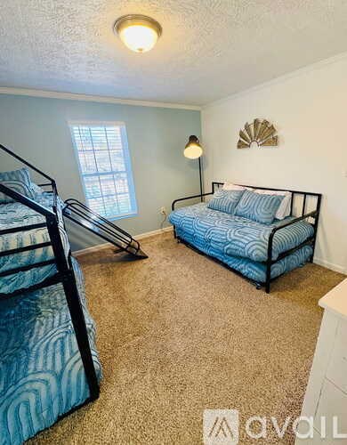 A bedroom with a bed and a bunk bed.