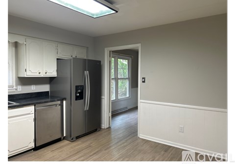A kitchen with a refrigerator, dishwasher, and oven.