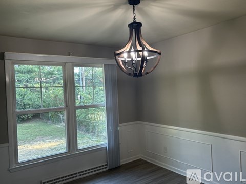 A room with a light hanging from the ceiling.