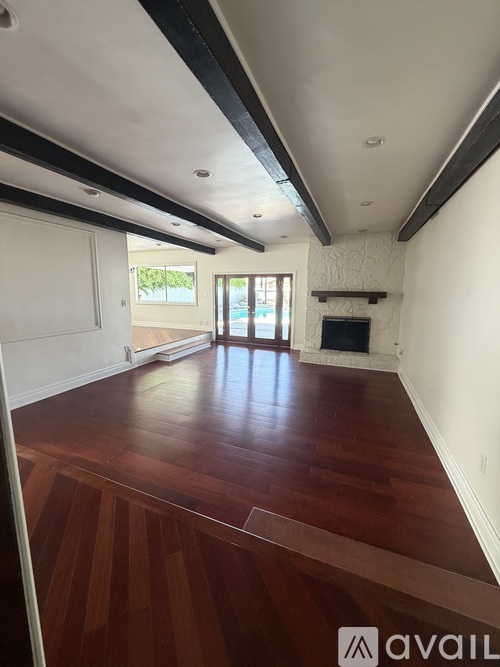 A room with wooden floors and a fireplace.