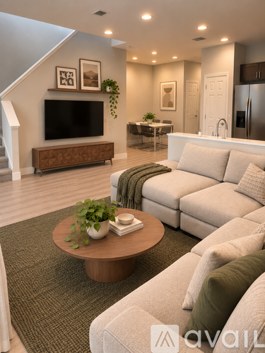A living room with a couch, coffee table, and a television.