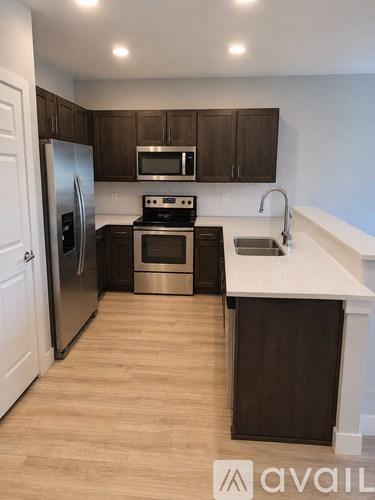 A kitchen with brown cabinets and a white countertop.