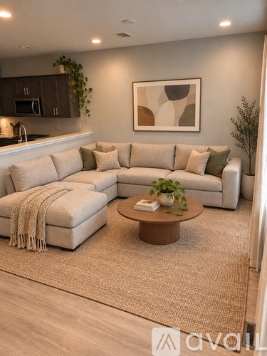 A living room with a large sectional sofa and a coffee table.