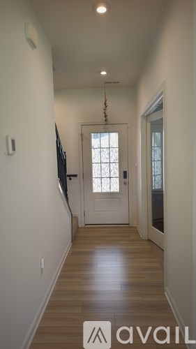 A long hallway with a door at the end.