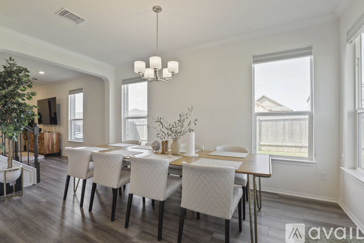 A dining room with a table set for four.