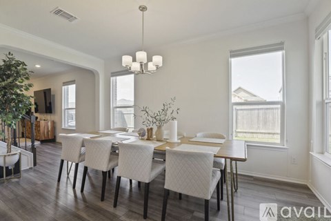 A dining room with a table set for four.