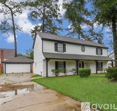 A house with a white exterior and a grey roof is shown.