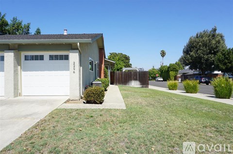 A house with a garage and a driveway in front of it.
