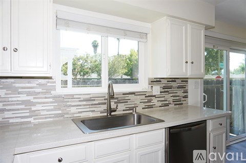 A kitchen with a sink and a window.
