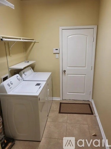 A small laundry room with a washer and dryer.